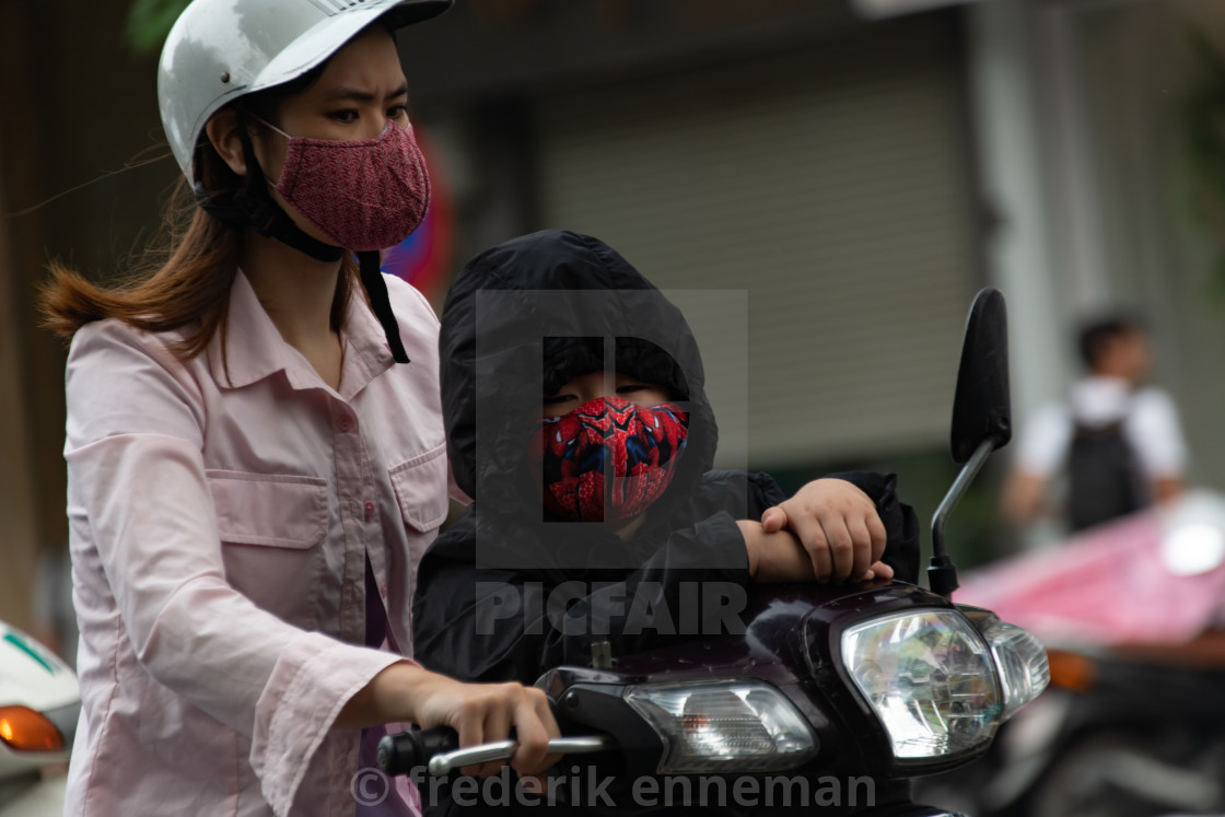 "People in Vietnam wearing facemasks against the air pollution and covid19" stock image