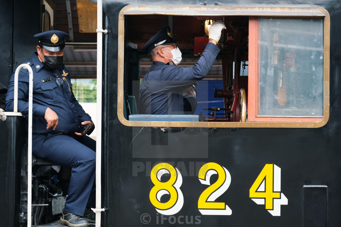 "Train drivers on board of locomotive" stock image