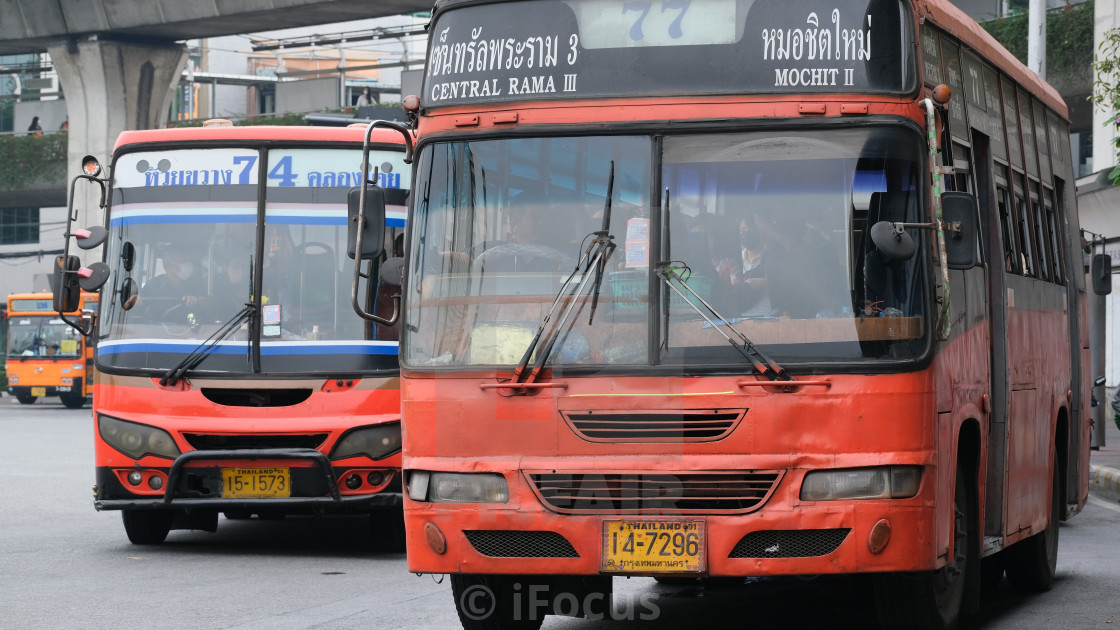 "Orange minibuses in Thai capital Bangkok" stock image