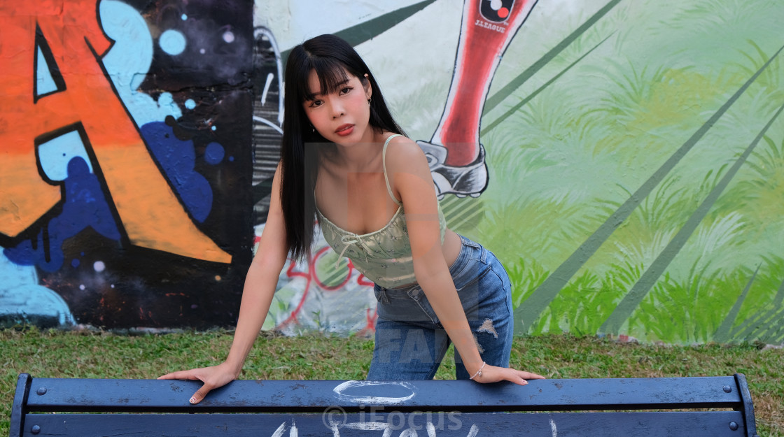 "Thai female model in front of graffiti art" stock image