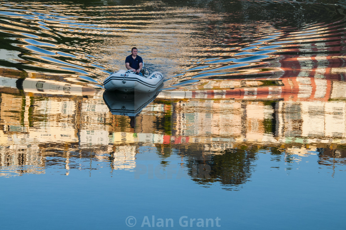 "Dinghy making colourful ripples in water" by Alan Grant - $15.19 "Dinghy making colourful ripples in water" stock image