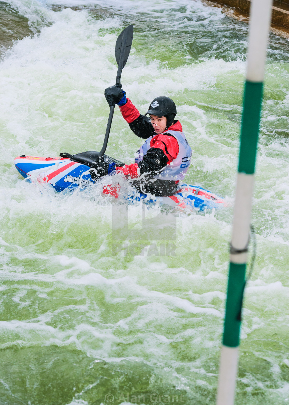 "Kayaker going through gates a Union Jack kayak" by Alan Grant - $15.18 "Kayaker going through gates a Union Jack kayak" stock image