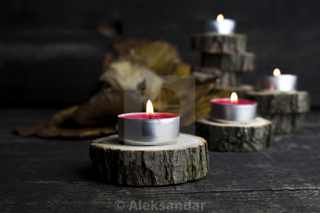 Christmas Candles Burning Decoration On Wooden Logs Resting On Rustic Wooden License Download Or Print For 3 00 Photos Picfair