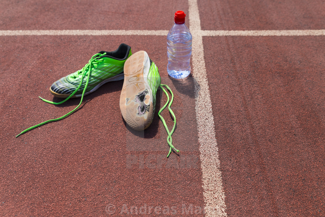 Broken green running shoes with water bottle - License, download or print  for £ | Photos | Picfair