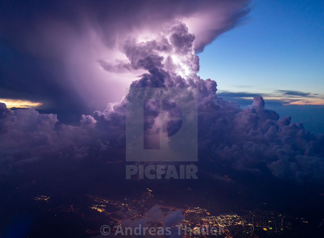 "intense thunderstorm with some lightning during sunset" stock image