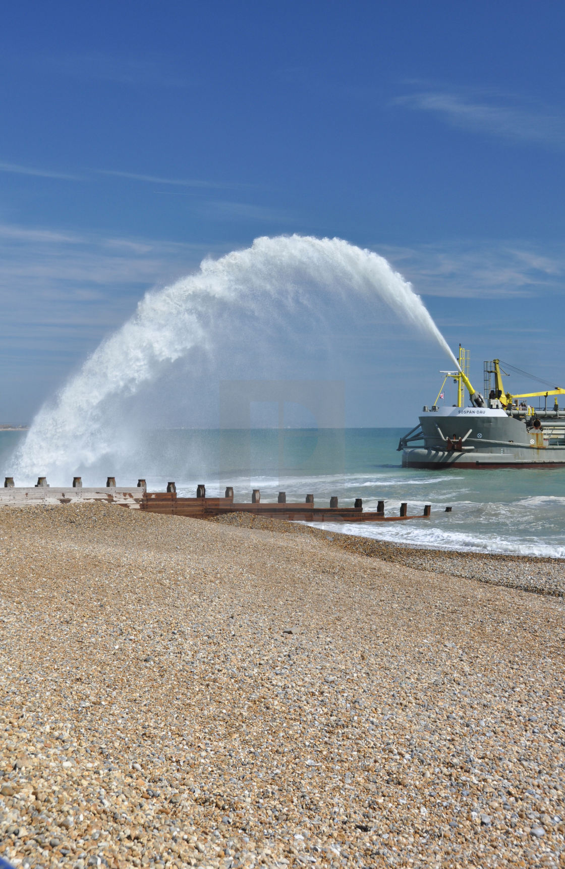 "Dredger ads to beach at Eastbourne, East Sussex, UK." stock image