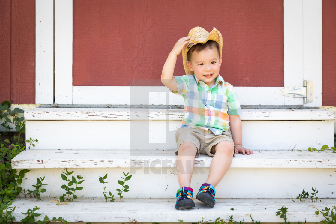 Young Mixed Race Chinese And Caucasian Boy Wearing Cowboy Hat