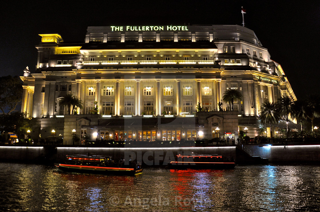 "Fullerton Hotel, Singapore at night" stock image