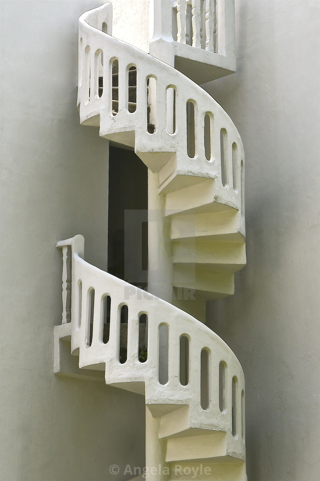 "White stone spiral staircase" stock image