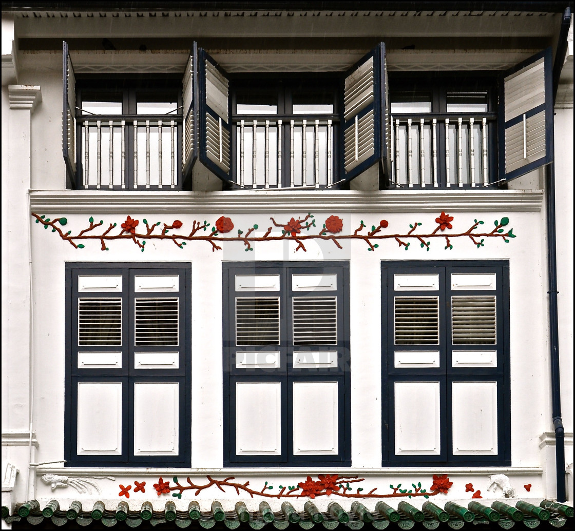 "White peranakan house with blue wooden shutters" stock image