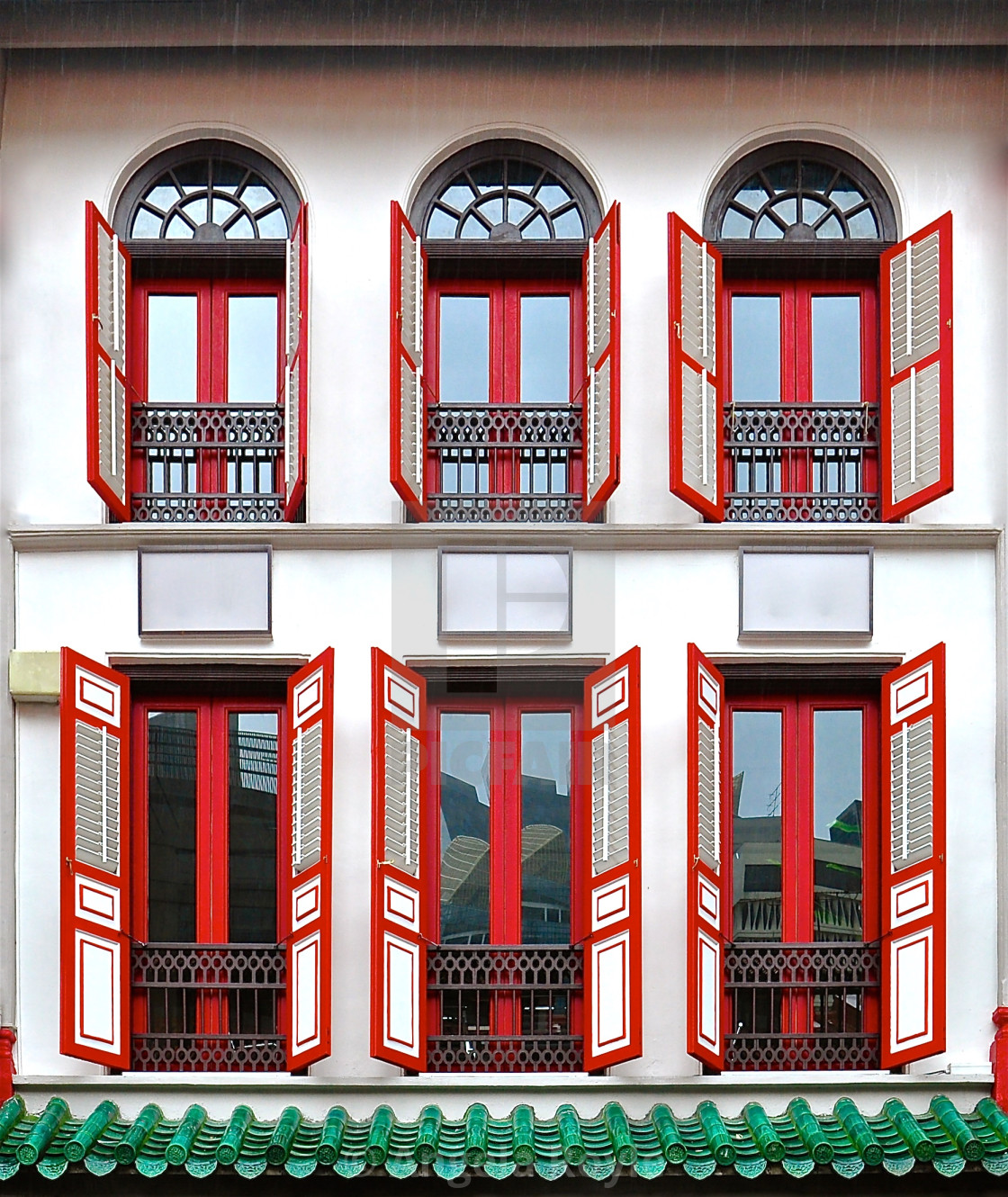 "White peranakan house with red wooden shutters" stock image