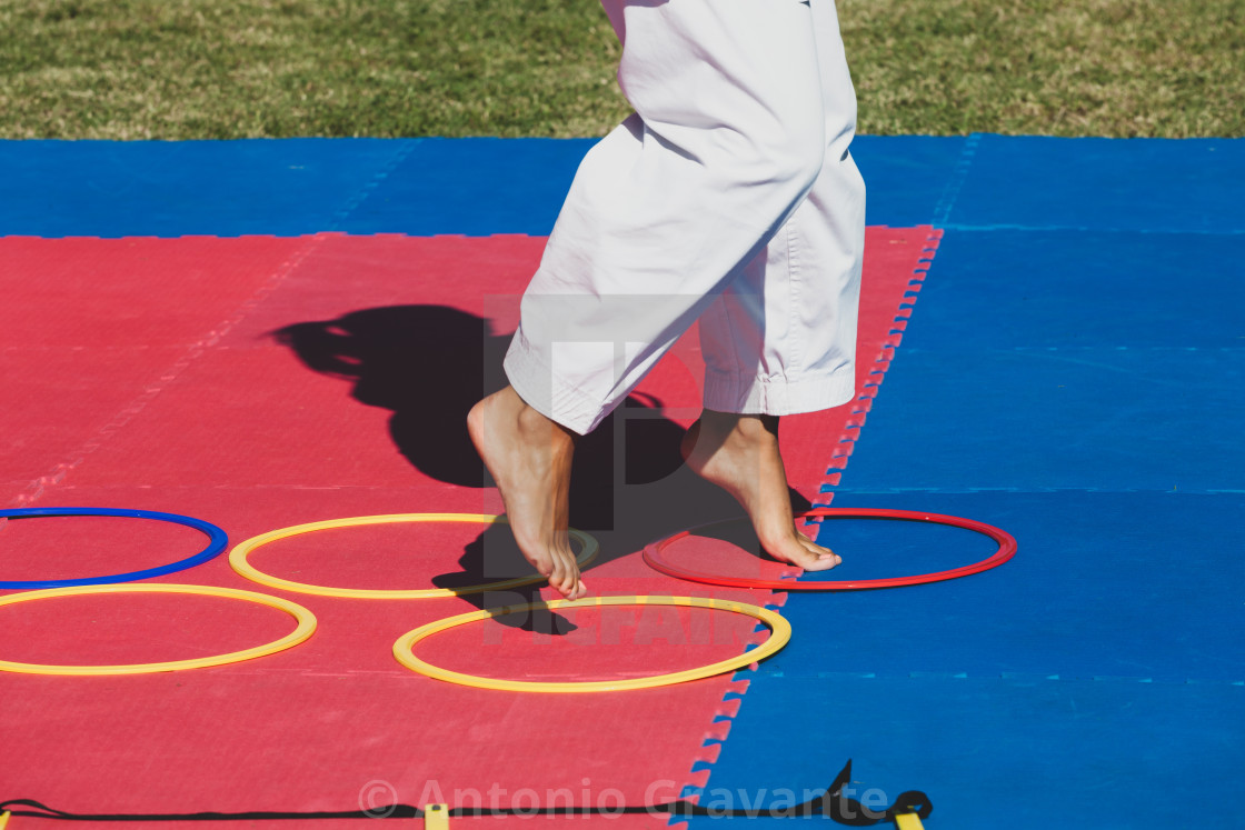"Martial arts teacher demonstrates to children how to jump in circles." by Antonio Gravante - $10.72 "Martial arts teacher demonstrates to children how to jump in circles." stock image