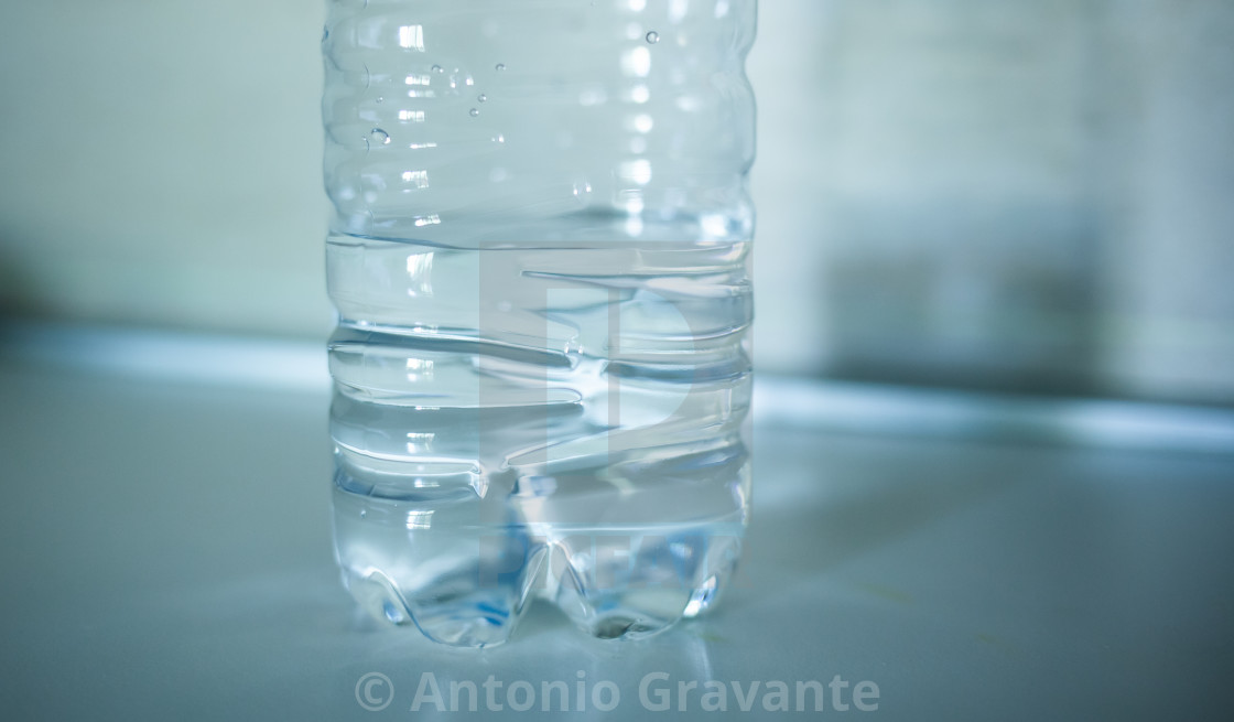 "Half bottle of water on the top of the kitchen." stock image