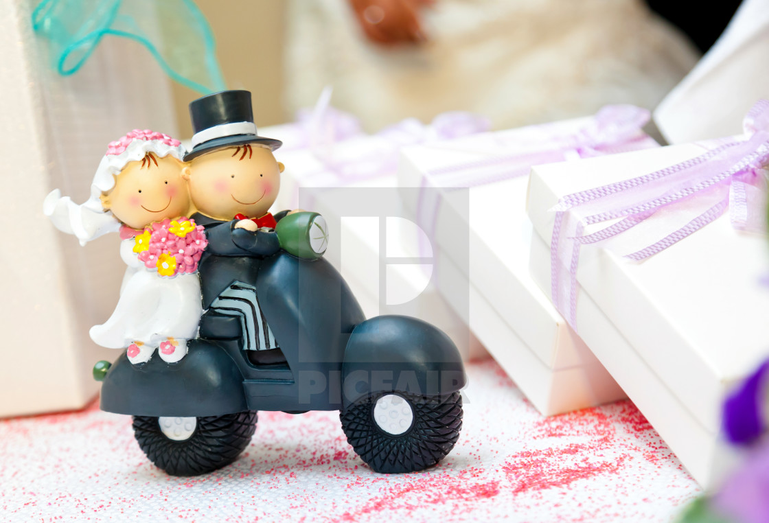 "Trinket depicting married couple on a scooter." by Antonio Gravante - $10.72 "Trinket depicting married couple on a scooter." stock image