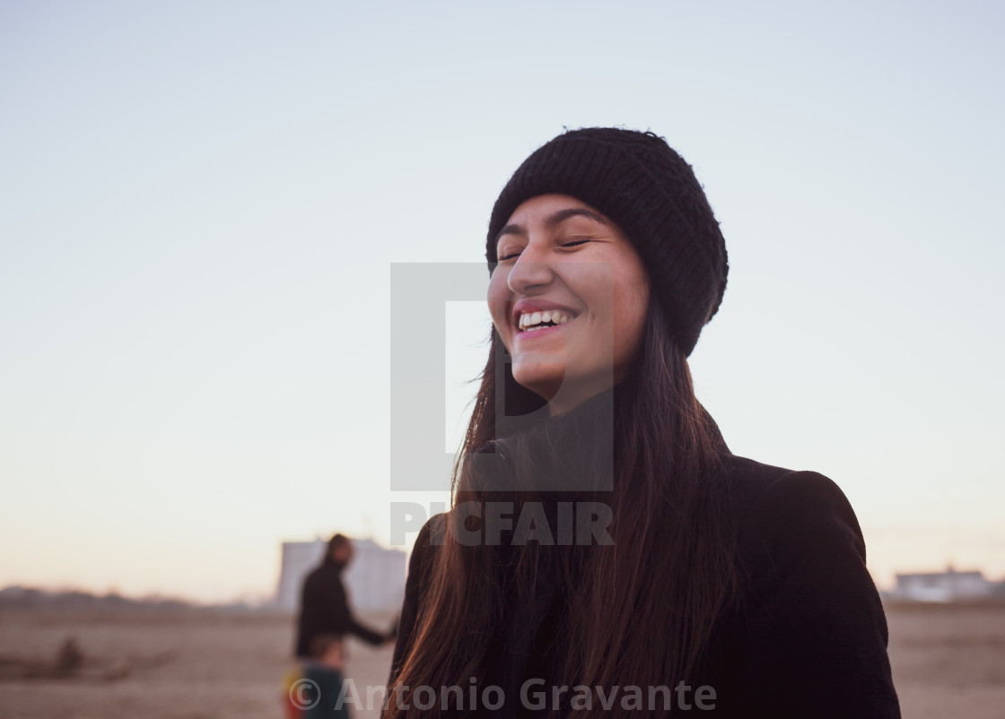 "Young woman in winter clothing with wool hat smiling with closed eyes." by Antonio Gravante - $10.72 "Young woman in winter clothing with wool hat smiling with closed eyes." stock image
