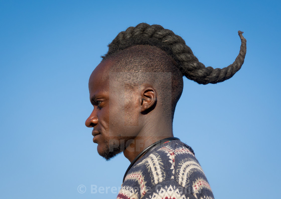 Himba tribe man with the traditional hairstyle, Cunene Province, Oncocua, Angola - License, download or print for £ | Photos | Picfair Himba tribe man with the traditional hairstyle, Cunene Province, Oncocua, Angola - License, download or print for £ | Photos | Picfair