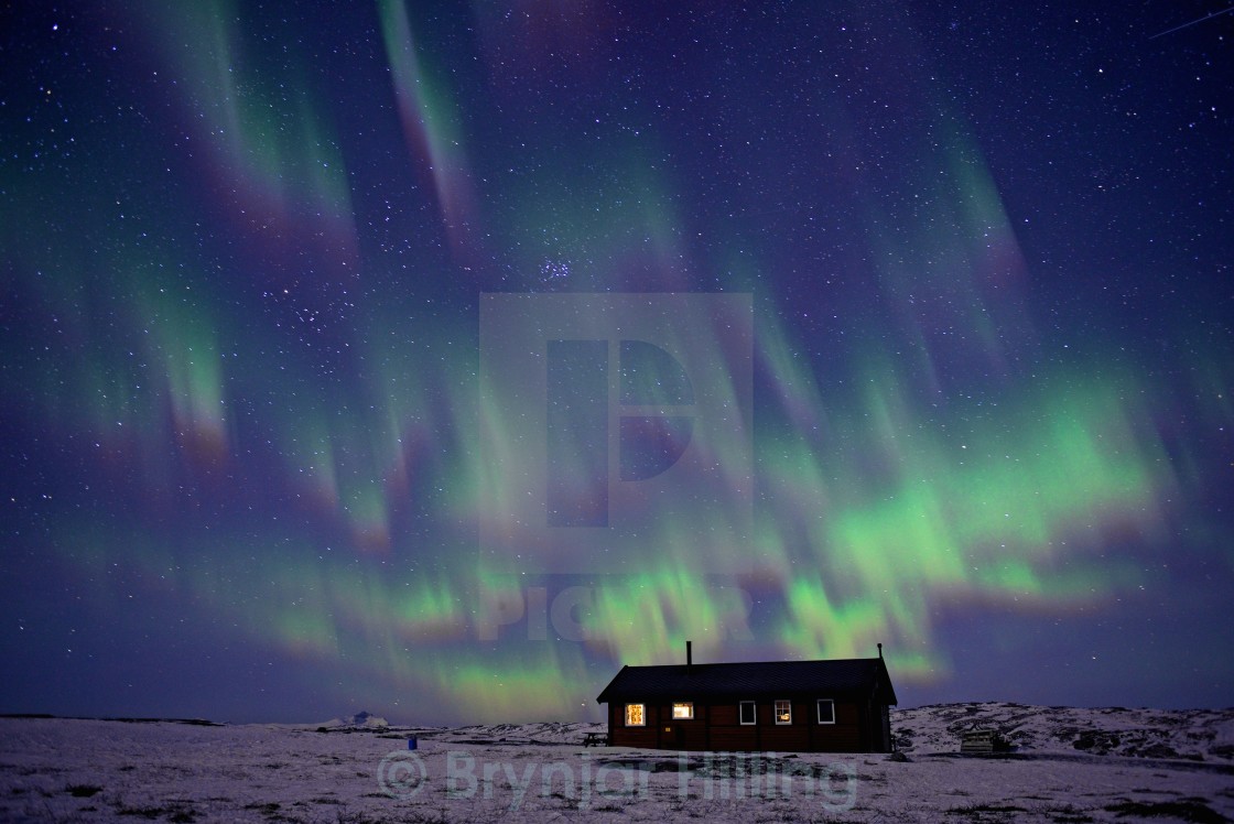 "Aurora Borealis over house" stock image