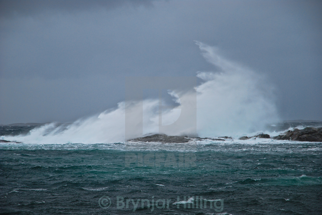 "wave hitting land" stock image