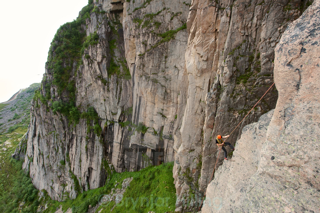 "Abseiling off the rock" stock image