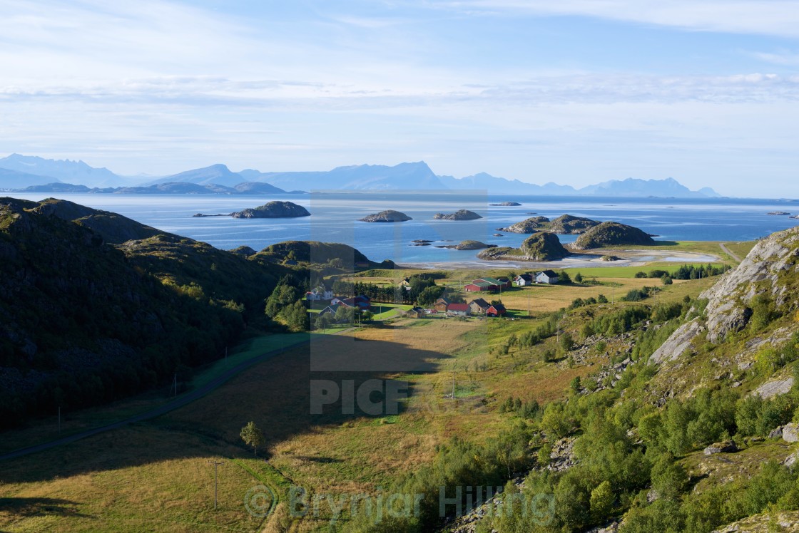 "fields and house on island" stock image