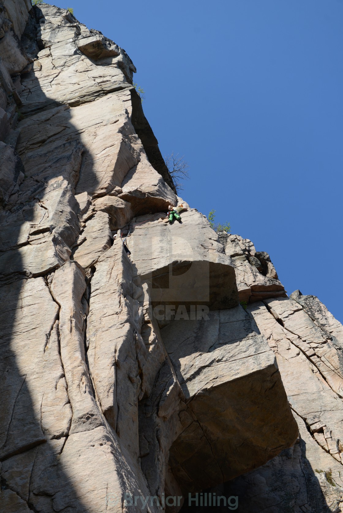 "Climbing up a steep rock" stock image