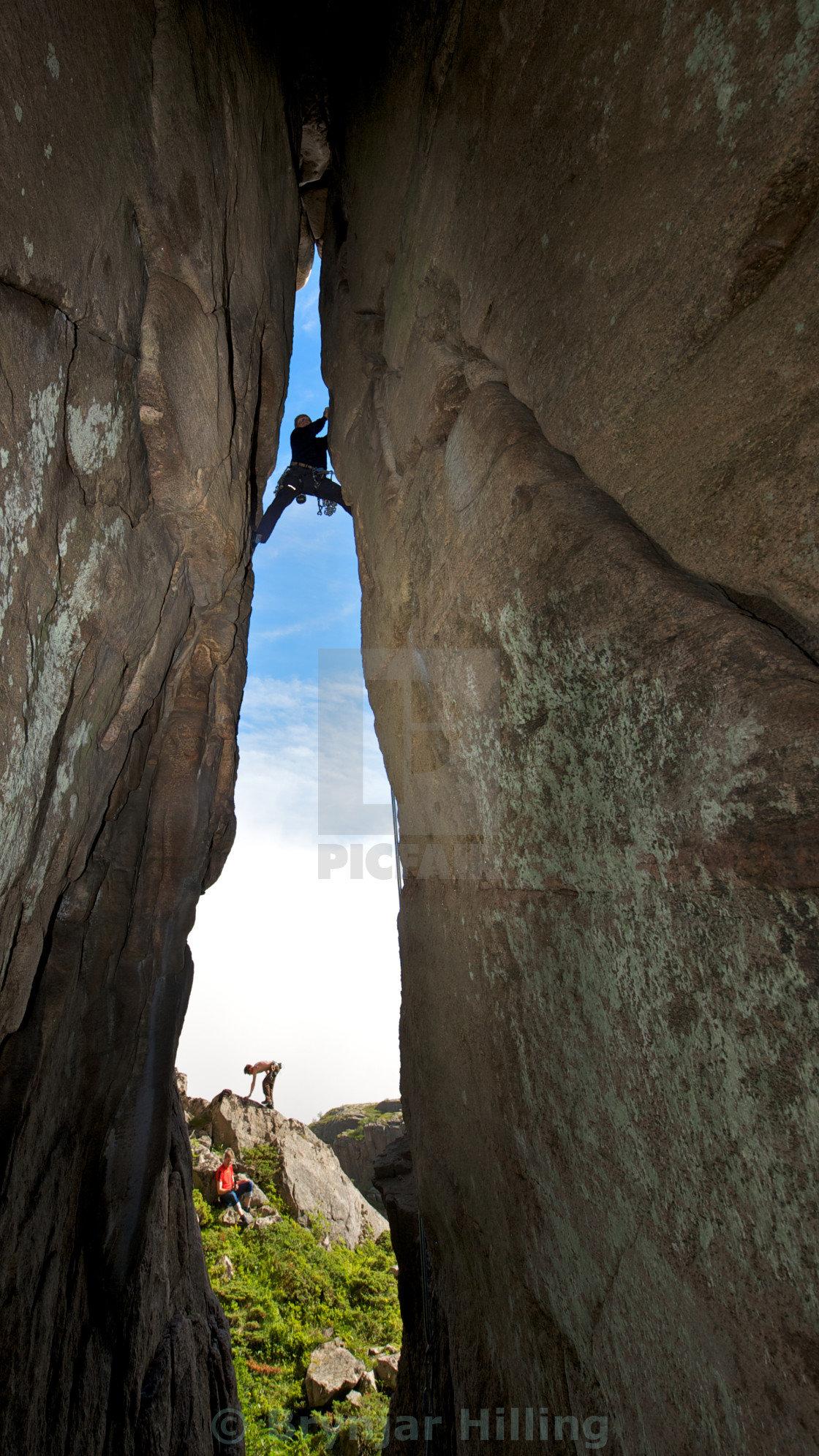 "Climbing a crack in the mountain" stock image