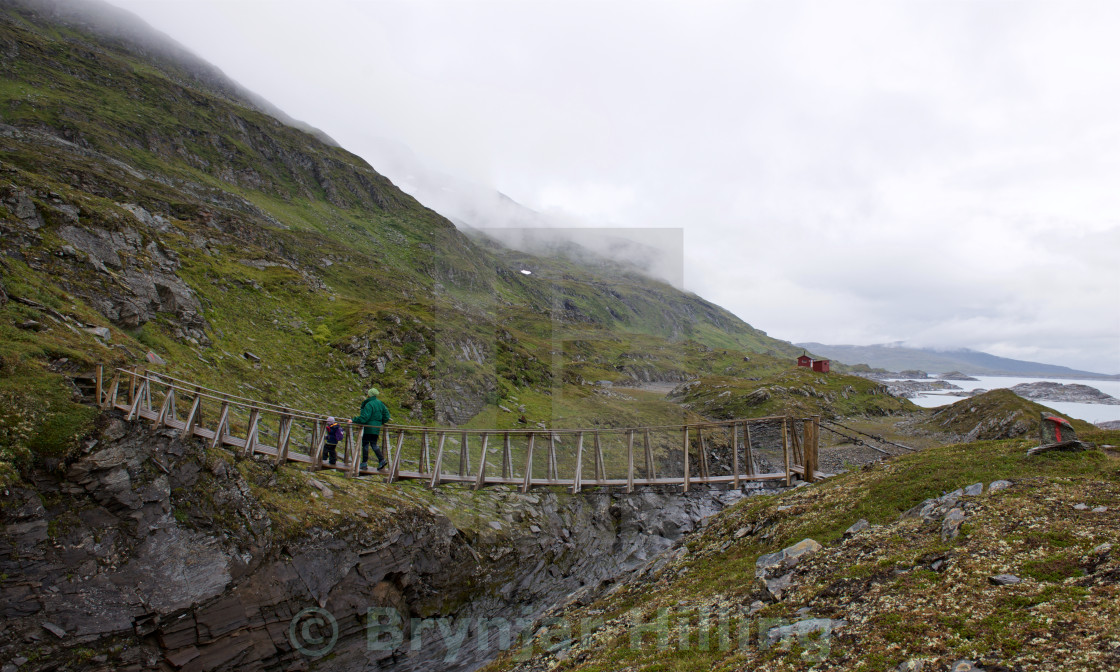 "Family going over bridge" stock image