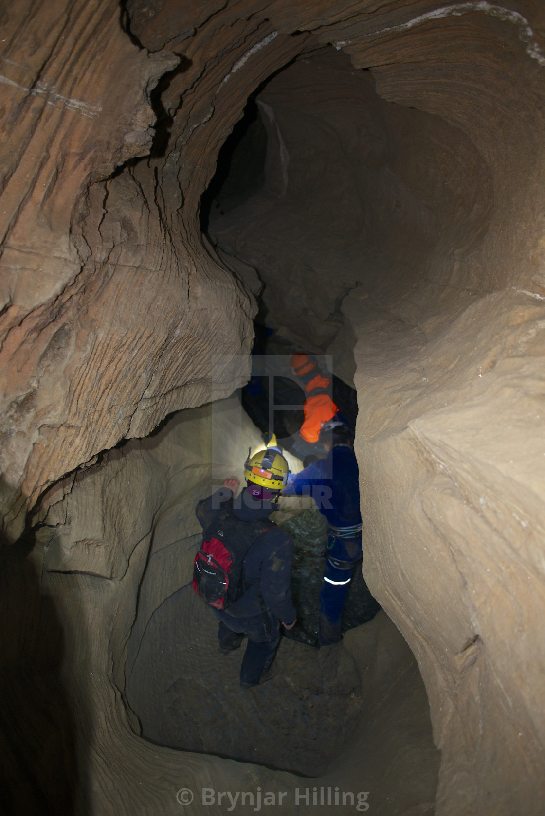 "People guided trough cave" stock image