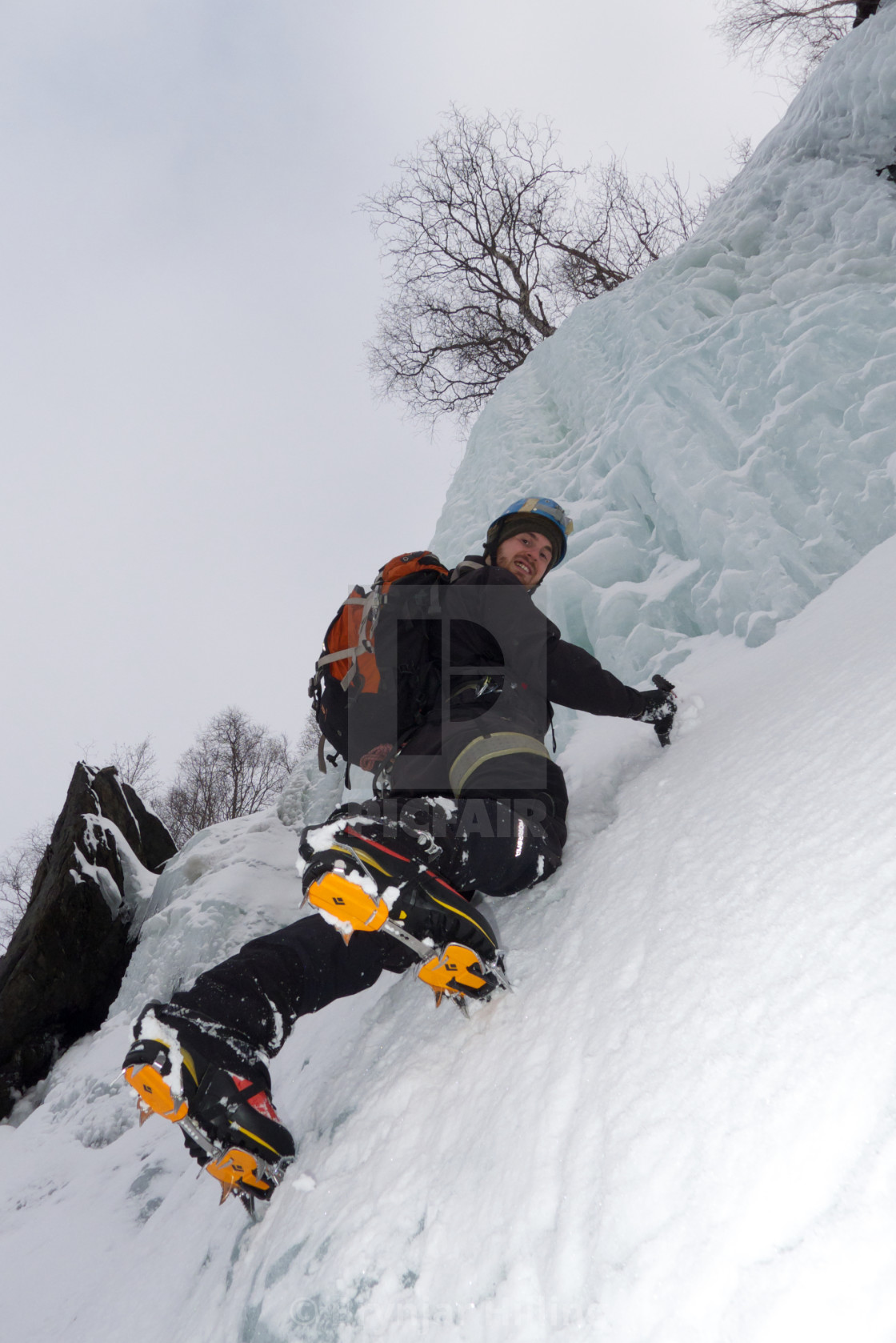 "Ice-climbing a frozen waterfall" stock image