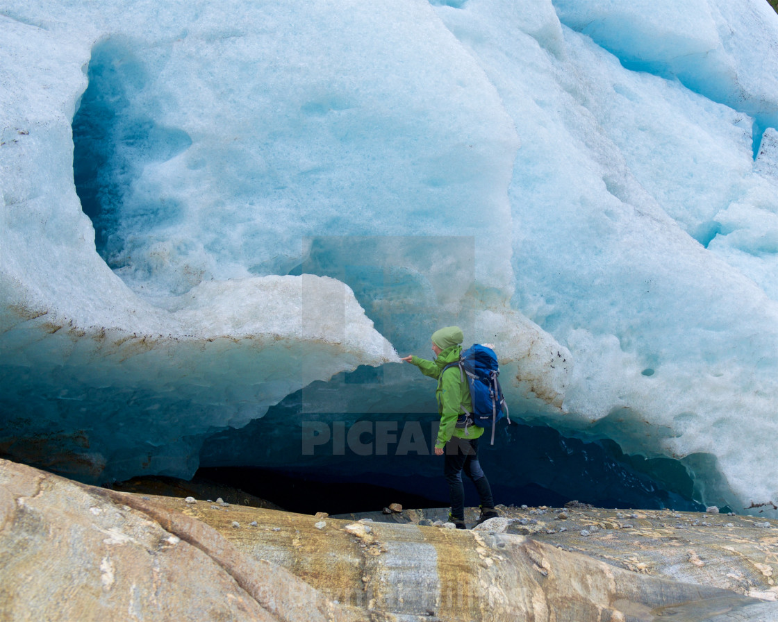 "Woman touching ice on a glacier" stock image