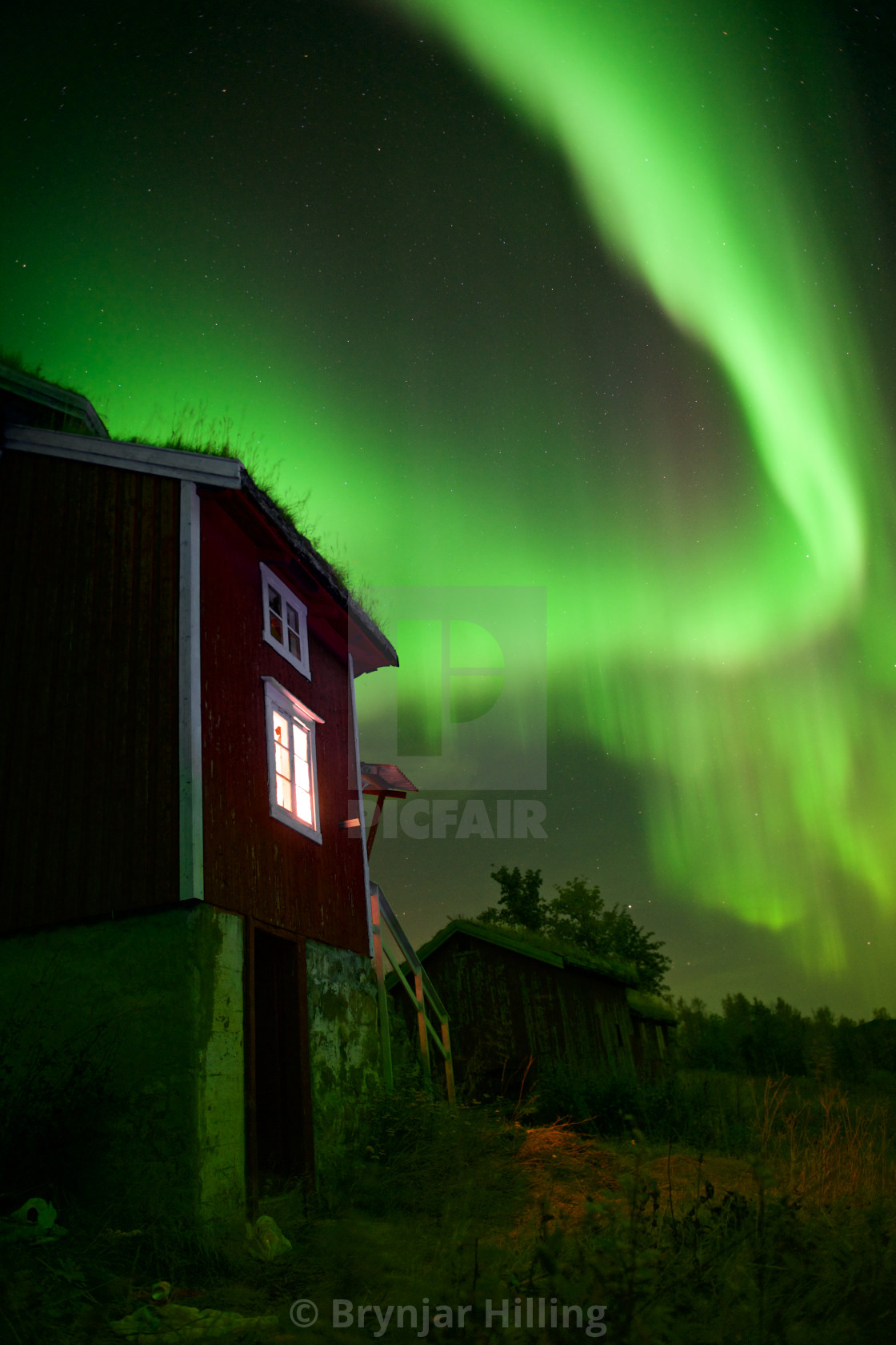 "Northern Lights over house" stock image