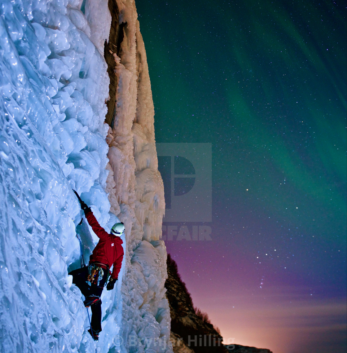 "Ice-climbing under aurora Borealis" stock image