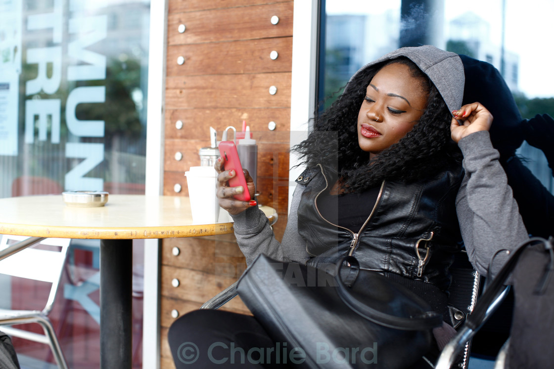 Black Woman In Black Casual Outfit At Coffee Shop License