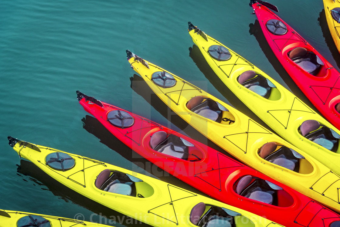 kayak background with many kayaks on the surface of the ocean with red ...