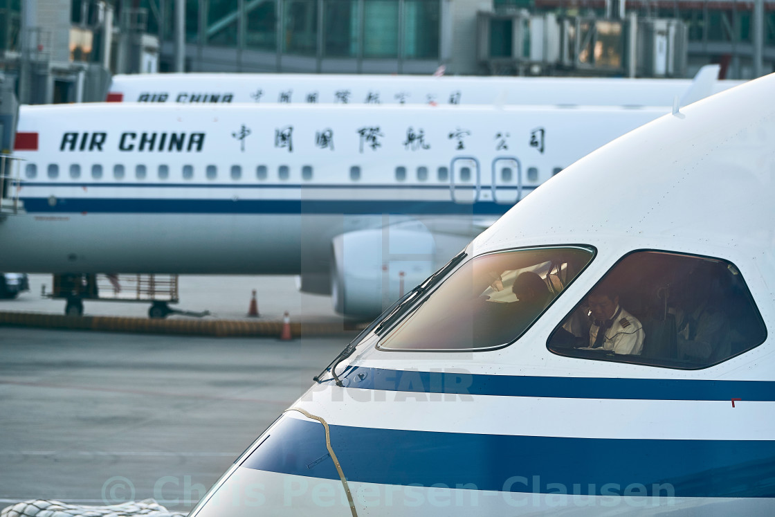 "Pilots inside Boeing 787 cockpit preparing for flight" stock image