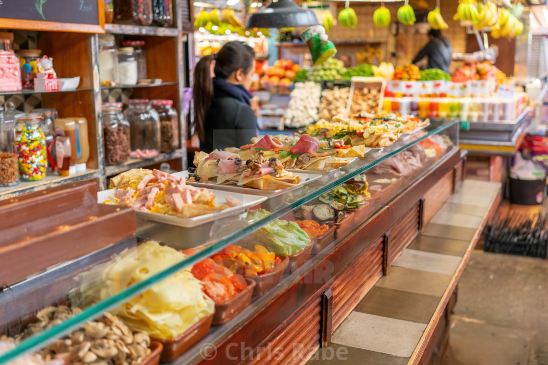 "Barcelona, Spain - January 29 2018 : A woman preparing food behind a counter..." stock image