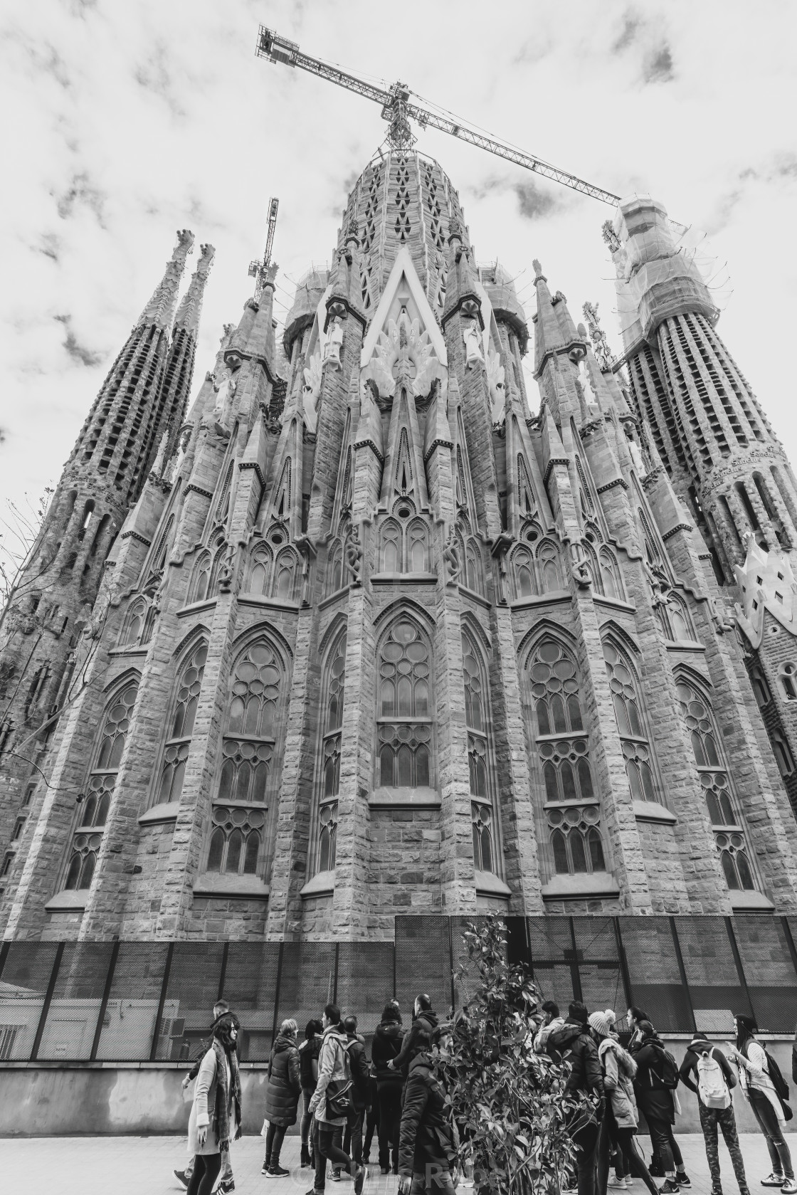 "Tourists gathered near the base of the main cathedral of Sagrada Familia,..." stock image