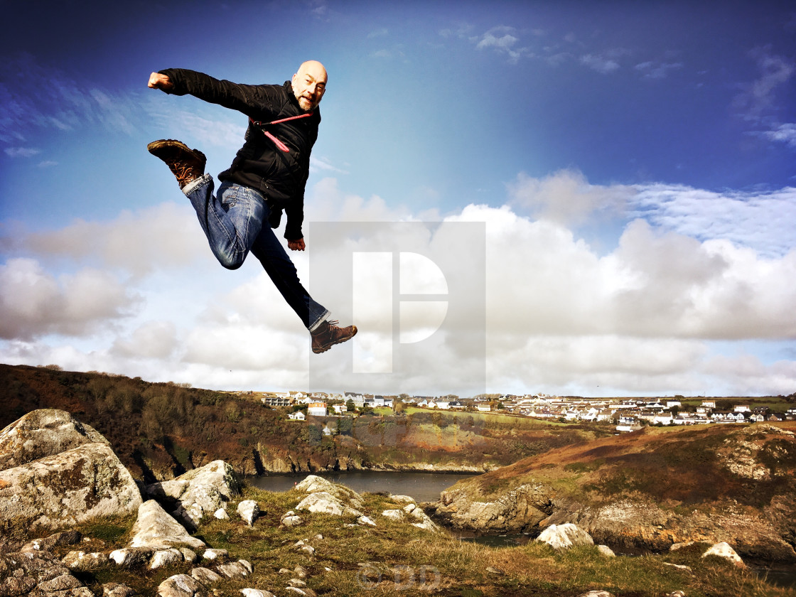"Man leaps off rocks in Pembrokeshire" by DD - $10.82 "Man leaps off rocks in Pembrokeshire" stock image