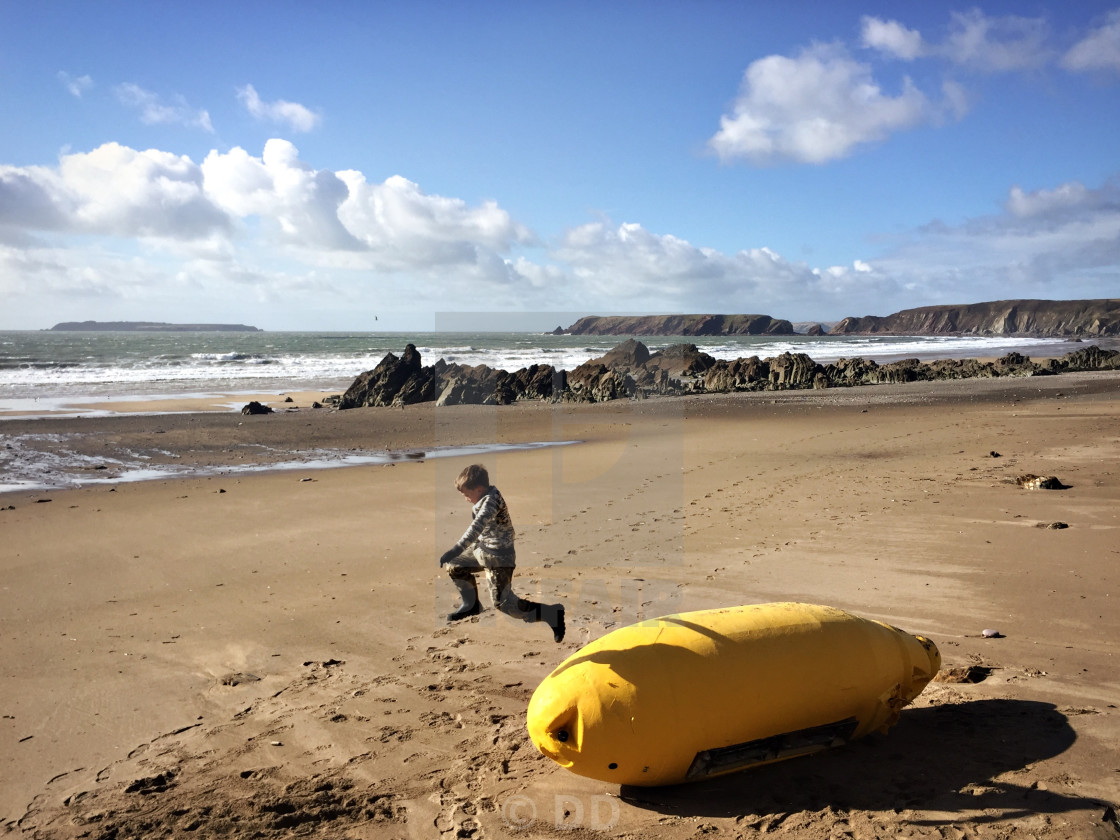"A boy jumps off a buoy on Marloes Sands beach" by DD - $15.46 "A boy jumps off a buoy on Marloes Sands beach" stock image