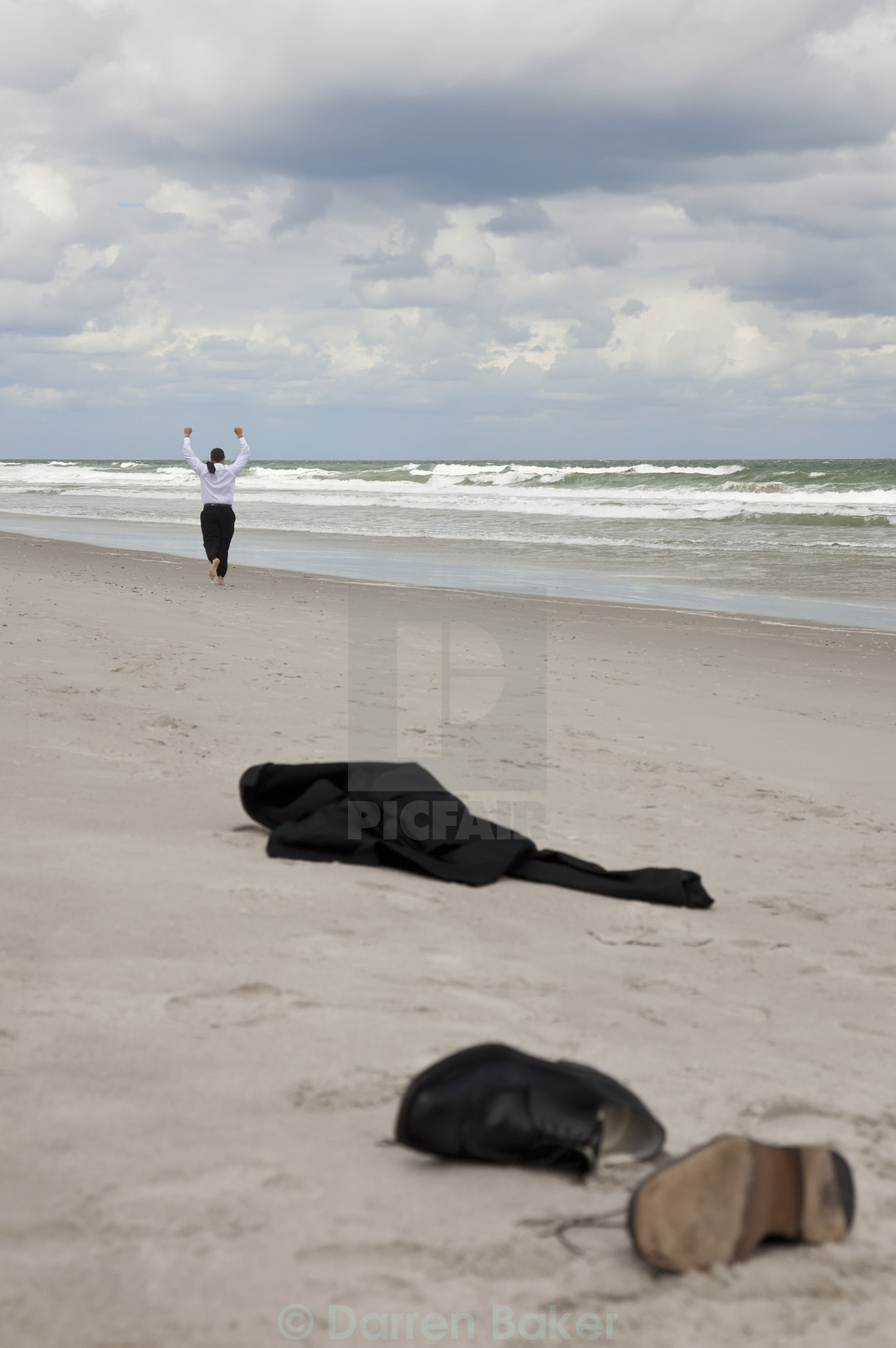 Businessman Leaving Clothes On Beach And Running Towards The Sea License Download Or Print For 12 40 Photos Picfair