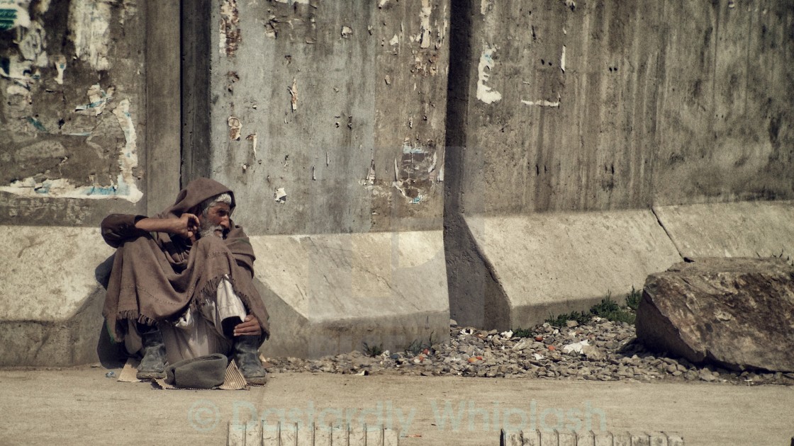 "Begging against the wall" stock image