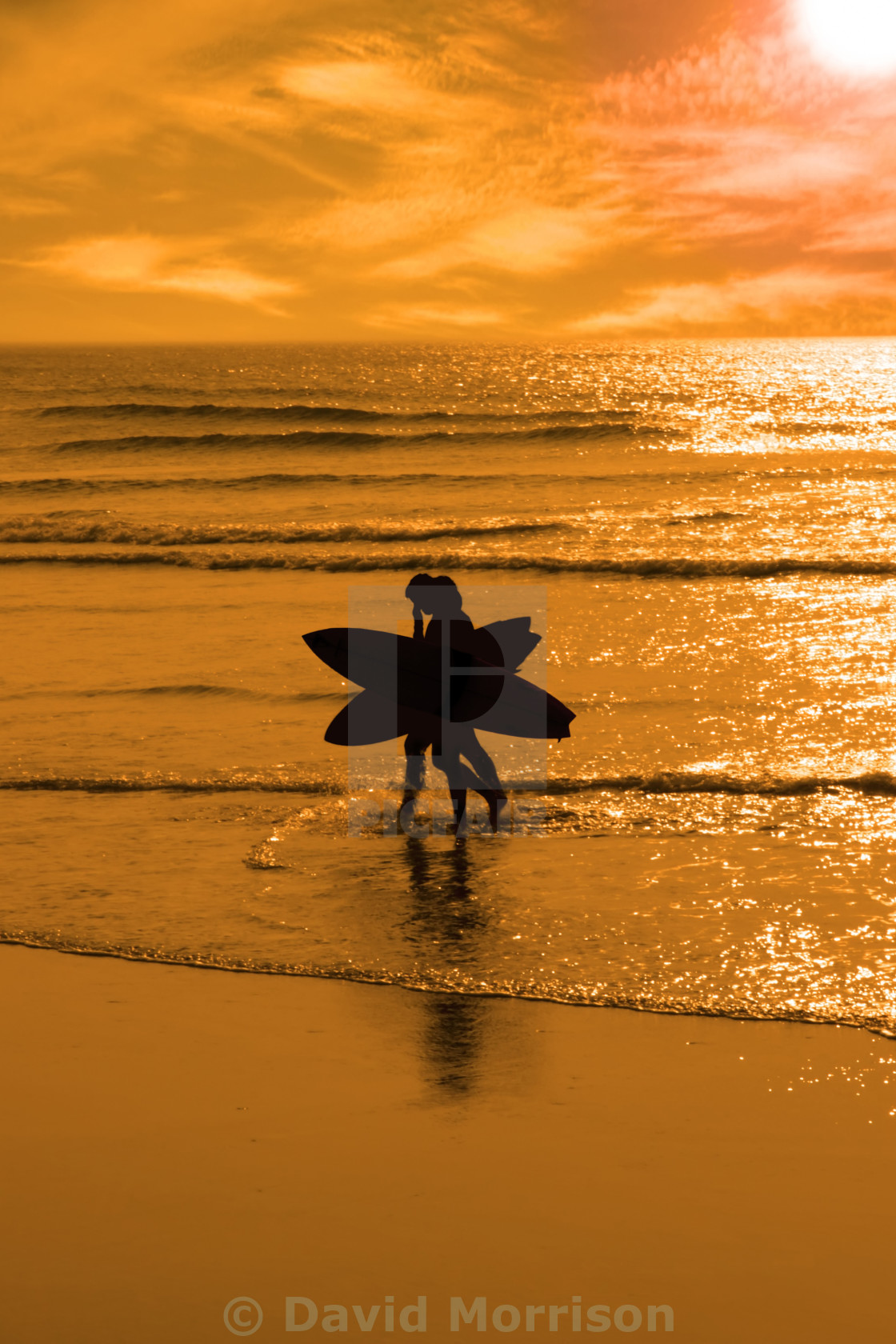 "angelic surfing couple silhouette" stock image