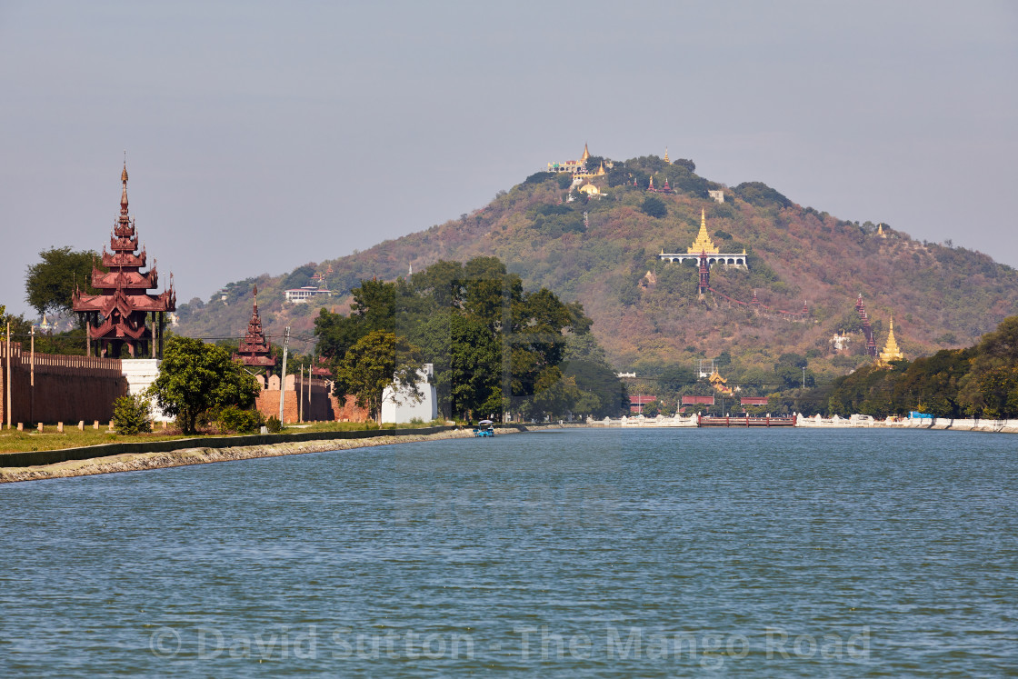 "Palace moat and Mandalay Hill, Mandalay, Myanmar. The Su Taung Pyae Pagoda..." stock image