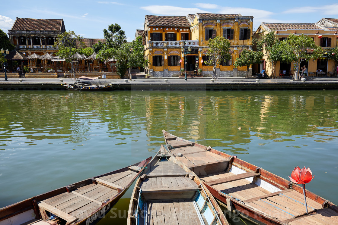 "Old buildings and boats on the banks of the Thu Bon River along Bach Dang..." stock image