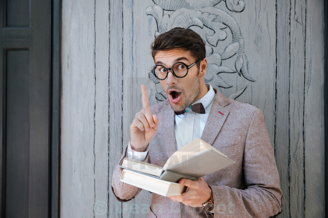 Funny man in round glasses reading book and having idea - License, download or print for £ | Photos | Picfair Funny man in round glasses reading book and having idea - License, download or print for £ | Photos | Picfair