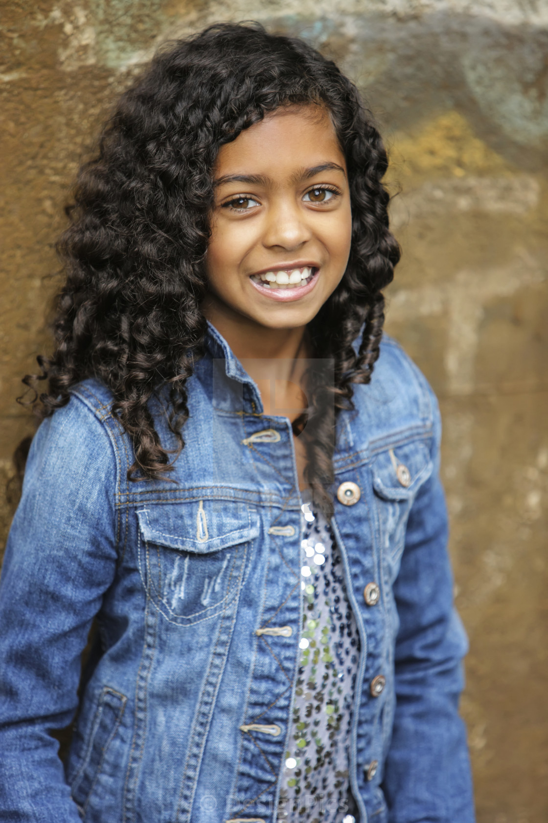 Portrait Of A Young Girl With Dark Curly Hair And Brown