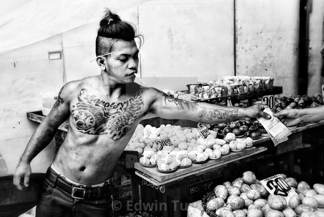 "Tattooed street vendor, Manila." stock image