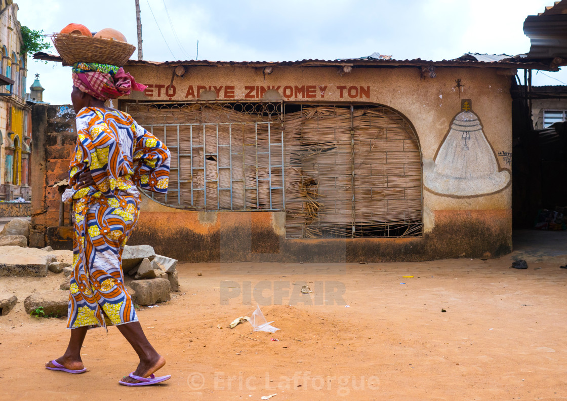 "Benin, West Africa, Porto-Novo, woman passing in front of a voodoo temple" stock image