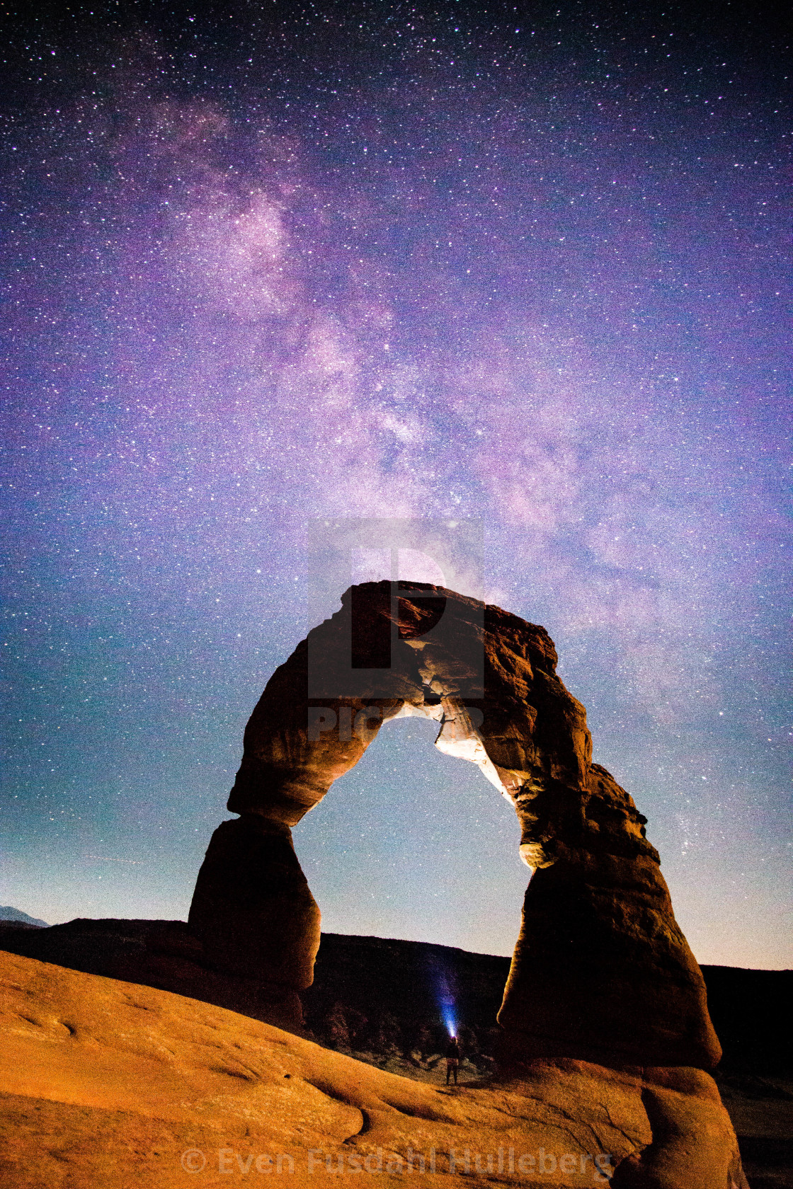 "People in nature, watching the Milky Way above Delicate Arch, Arches National Park, Utah" stock image