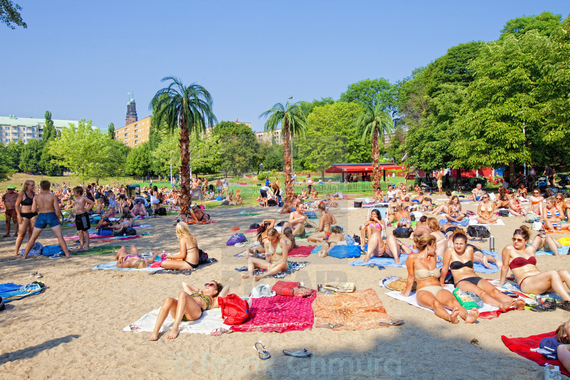 Sweden, Stockholm - People Sunbathing on Beach at ...
